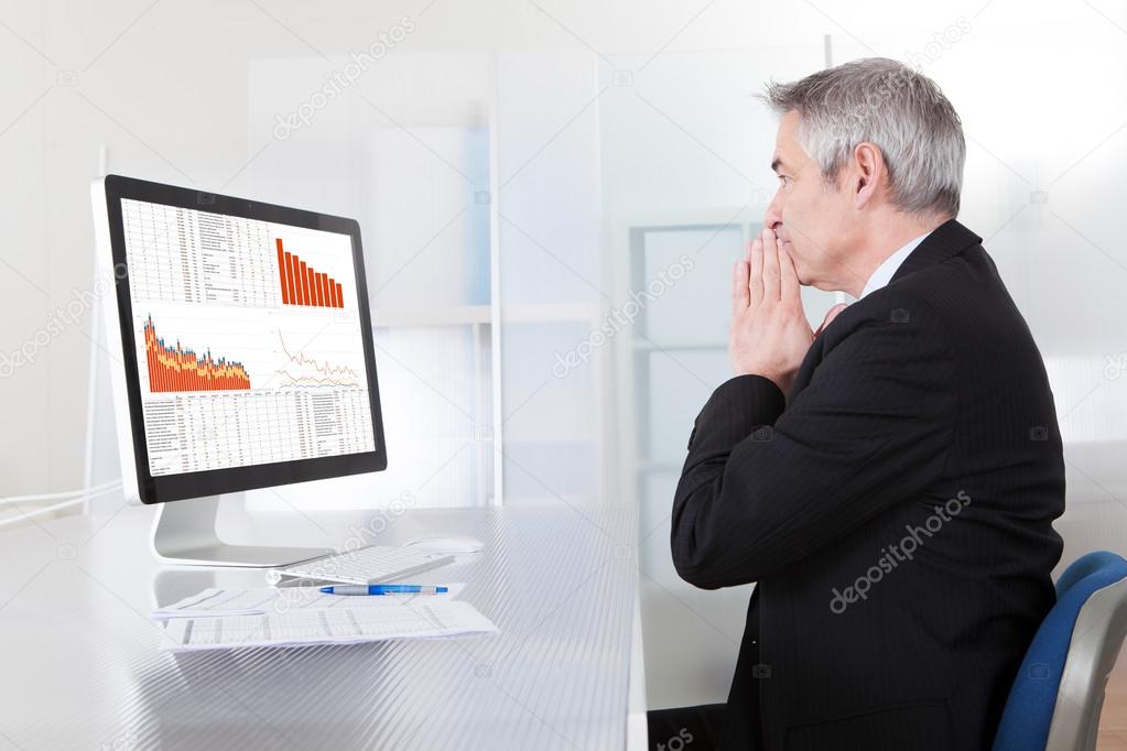 Confused Businessman With Computer