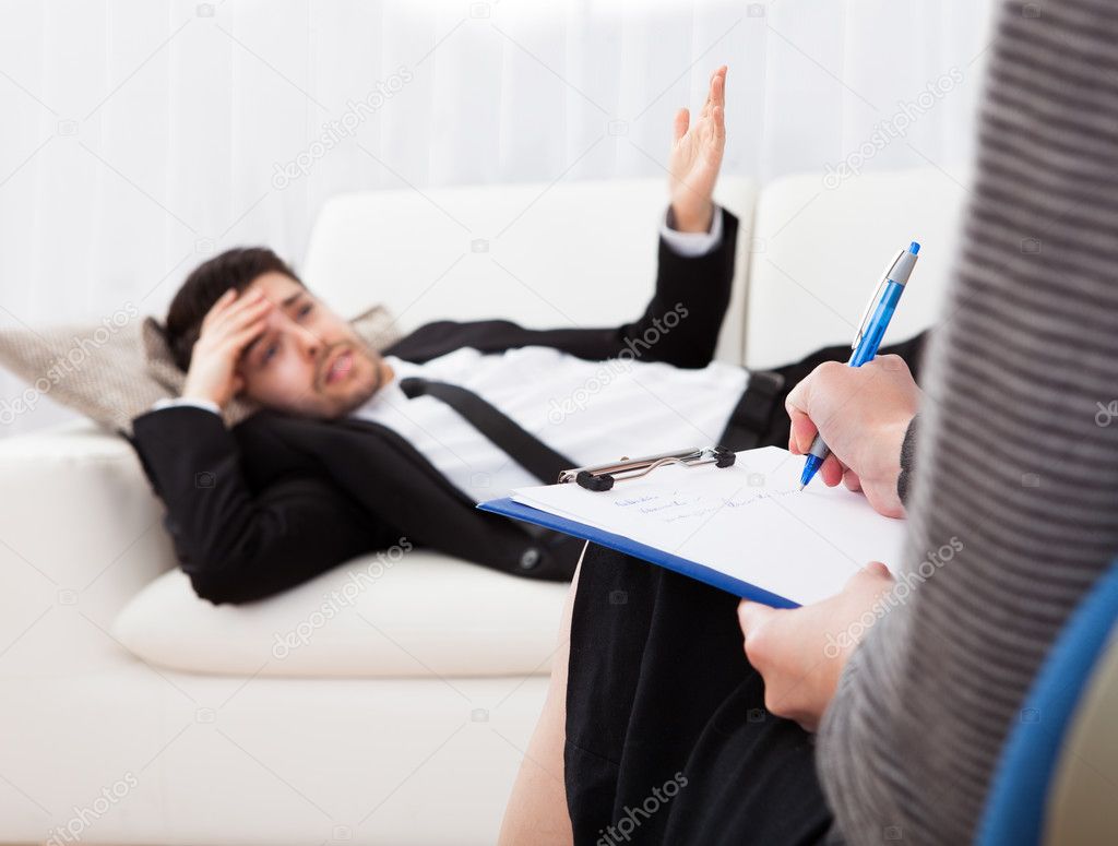Business man talking to his psychiatrist explaining something