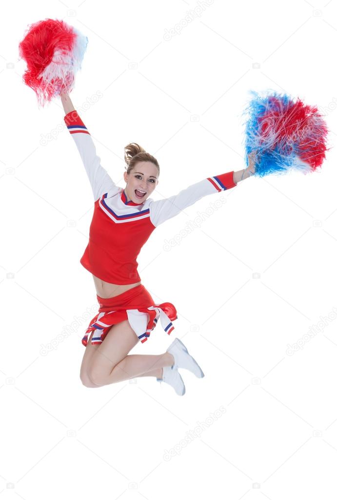 Happy Young Cheerleader Jumping With Pom-poms