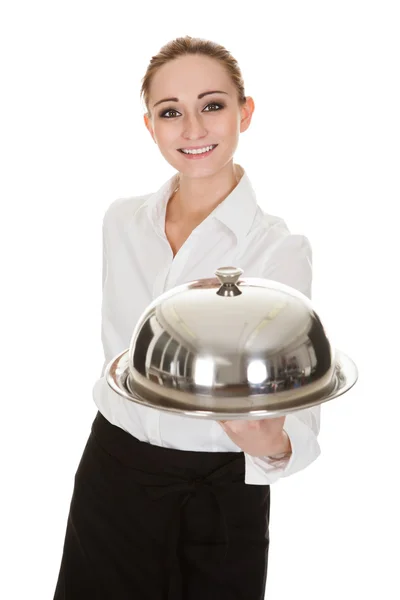 Молодая официантка держит поднос и крышку — стоковое фото