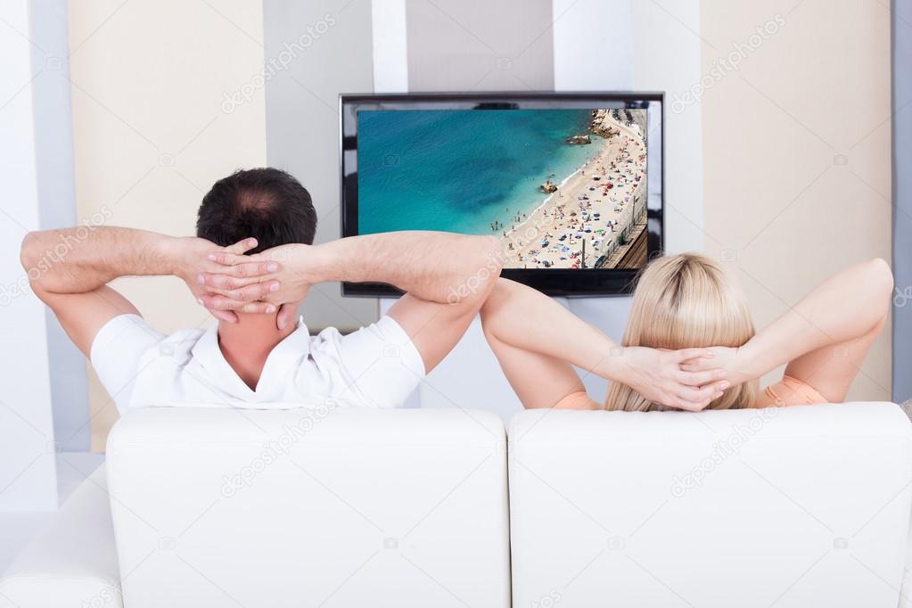 Portrait of couple watching television