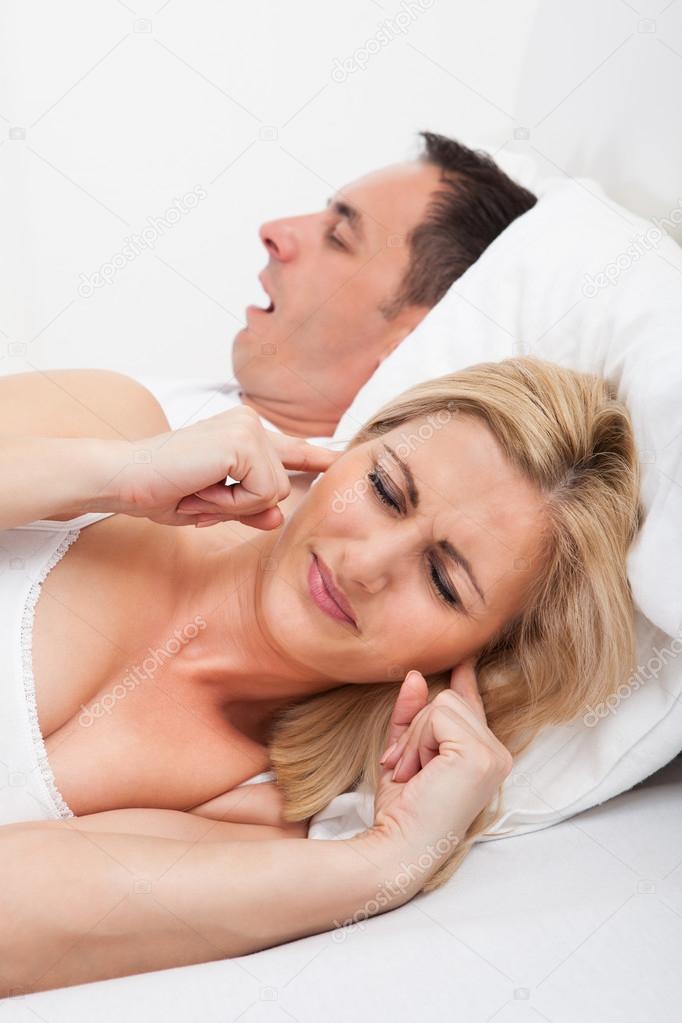 Woman Looking At Snoring Man