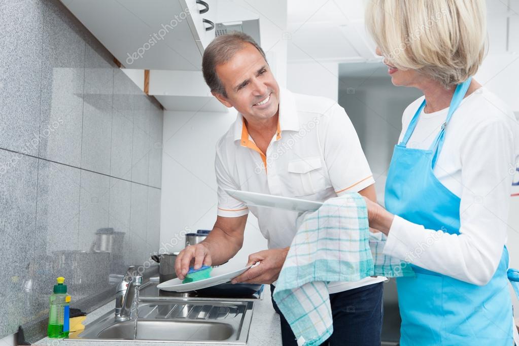 Mature Couple Cleaning Utensils