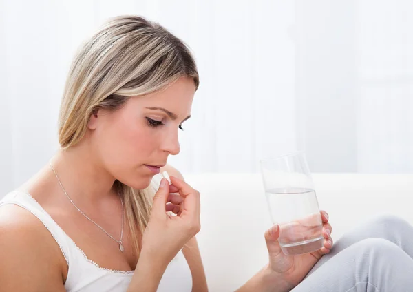 Portret van vrouw nemen van pillen — Stockfoto