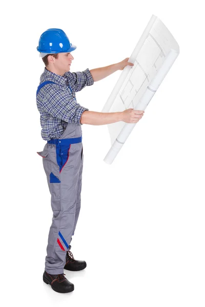 Architect looking at blue print — Stock Photo, Image