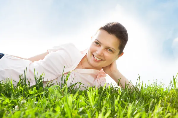 Jeune femme relaxant dans les prairies — Photo