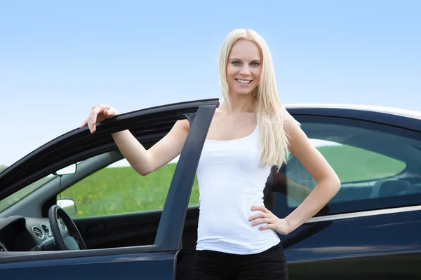 Young Woman Standing In Front Of Her Car Stock Photo