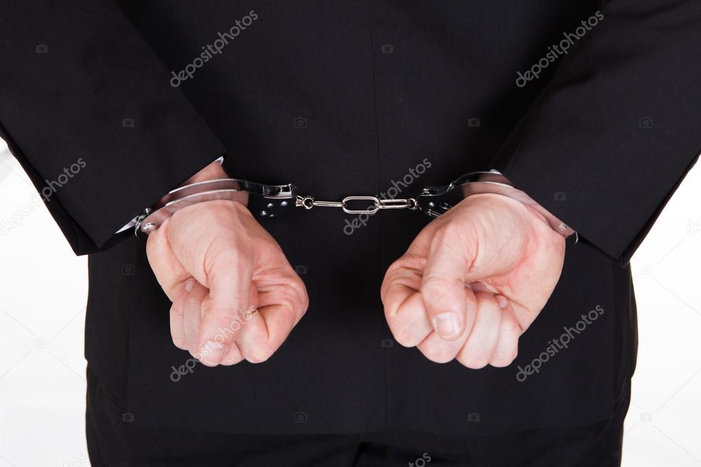 Close-up of arrested businessman