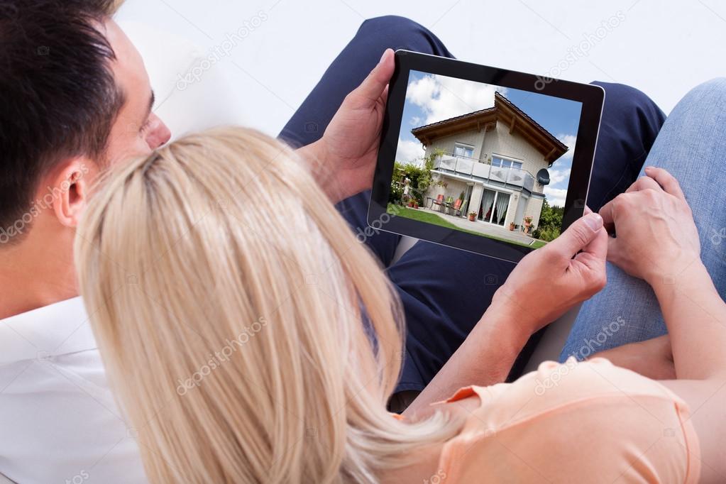 Couple Looking At Digital Tablet