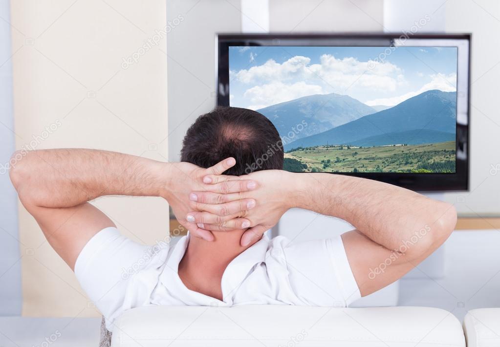 Man watching television at home