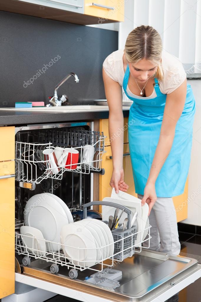 Woman Putting Dishes In The Dishwasher — Stock Photo © AndreyPopov