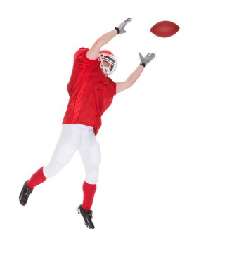 Portrait Of American Football Player Catching A Ball