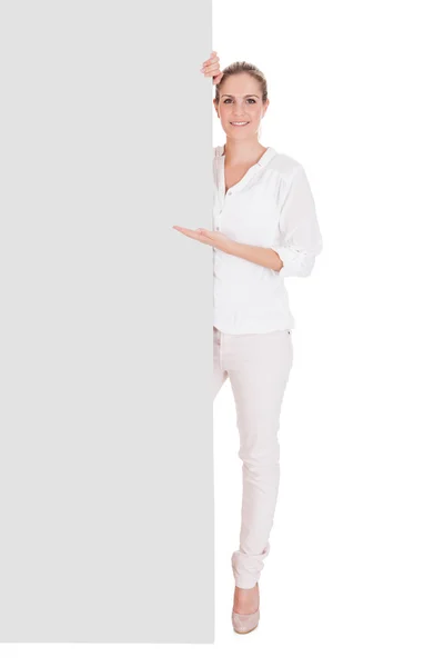 Young woman presenting blank placard — Stock Photo, Image