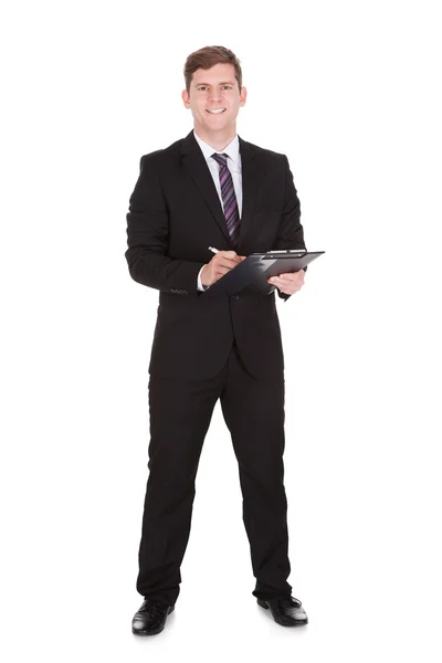 Feliz hombre de negocios sujetando portapapeles — Foto de Stock