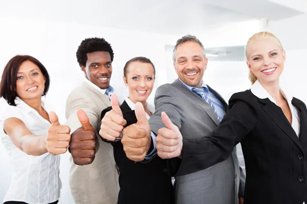 Businesspeople Gesturing Thumb Up Sign Royalty Free Stock Images