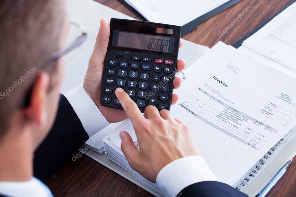 Businessman Using Calculator