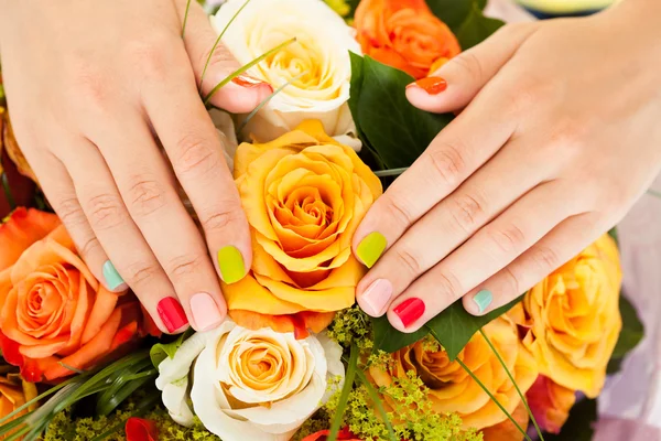 Female Hand On Flowers