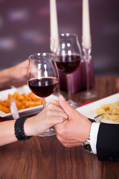 Couple Holding Hand At Restaurant