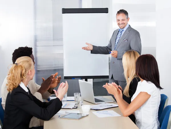 Geschäftsleute klatschen für einen Mann im Meeting — Stockfoto