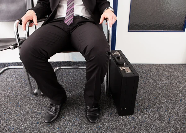 Man sitting on chair — Stock Photo, Image