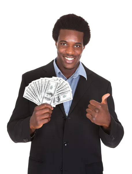 Nadšený podnikatel drží dolar měny — Stock fotografie