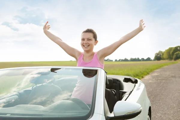 Woman Raising Hand In Car — Stock Photo, Image