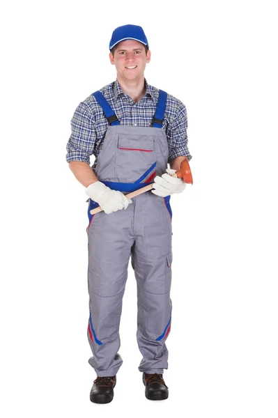Happy plumber holding plunger — Stock Photo, Image