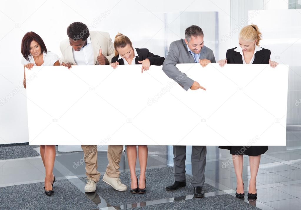 Multiracial Businesspeople Holding Placard