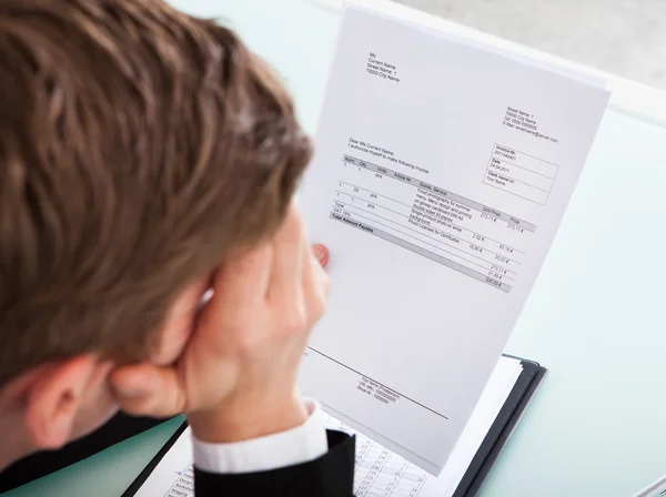 Businessman holding invoice paper — Stock Photo, Image