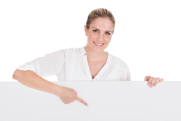Young woman presenting blank placard — Stock Photo, Image