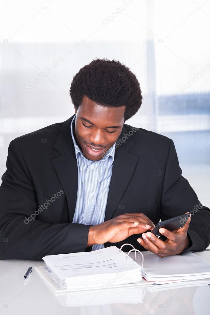 Happy Businessman Calculating Finance