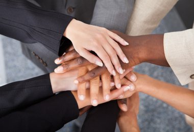 Multiracial Businesspeople Stacking Hands clipart