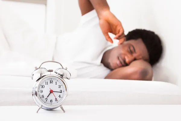 Frustrated Man In Front Of Alarm Clock — Stock Photo, Image