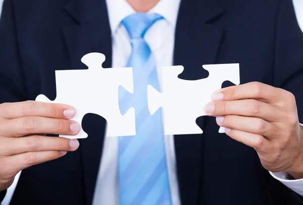 Businessman Holding Jigsaw Puzzle — Stock Photo, Image