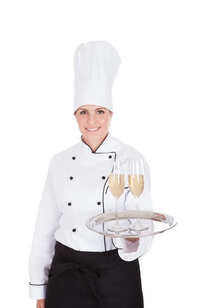 Kobieta kucharz gospodarstwa szampana — Zdjęcie stockowe