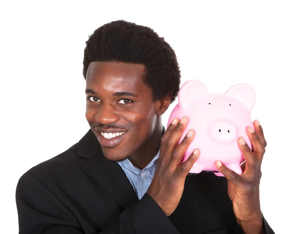 Afrikai üzletember gazdaság Piggybank — Stock Fotó