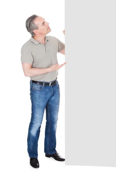 Happy Mature Man Standing Behind Placard — Stock Photo, Image