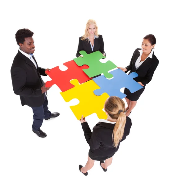 Multiracial Businesspeople Holding Jigsaw Puzzle — Stock Photo, Image