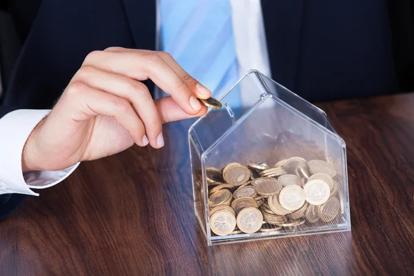 Empresario Insertando Moneda en Caja — Foto de Stock