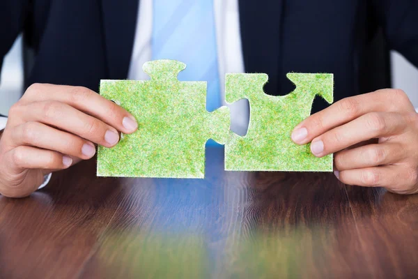 Businessman Holding Eco Friendly Jigsaw Puzzle — Stock Photo, Image