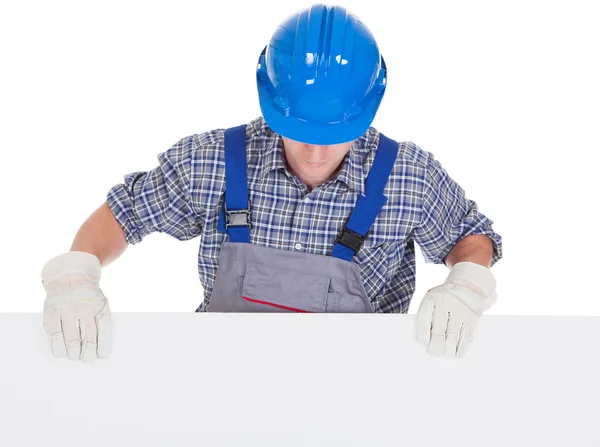Male worker holding blank placard — Stock Photo, Image