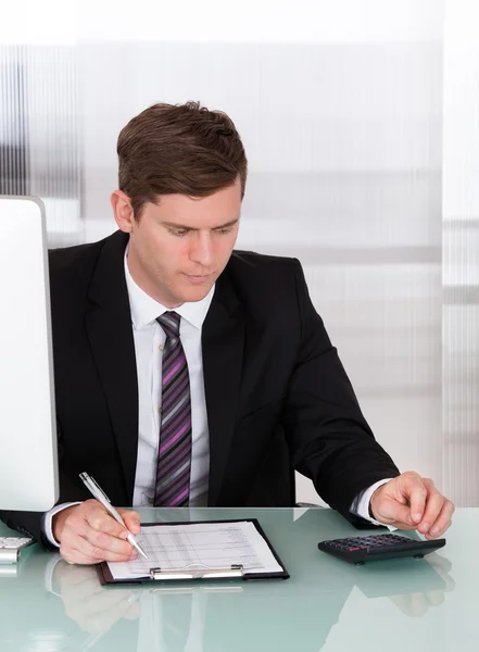 Young man calculating finances Royalty Free Stock Images