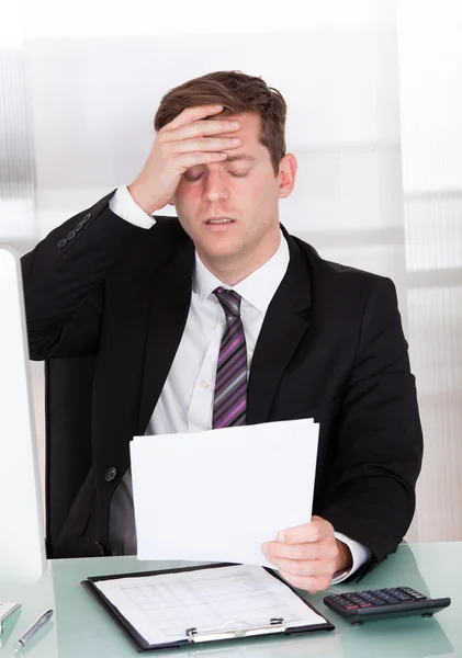 Anxiety businessman sitting in office Stock Image