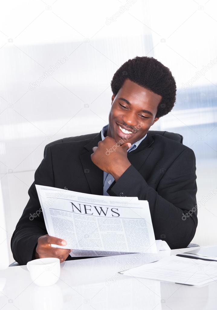 Happy Businessman Reading Newspaper