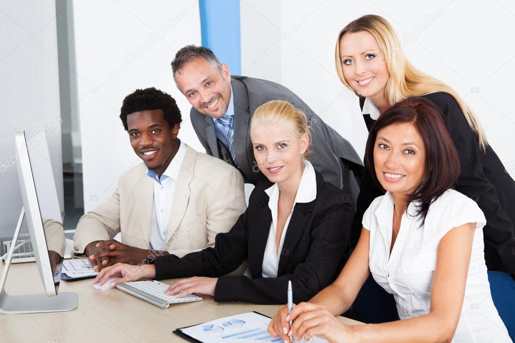 Group Of Businesspeople Looking At Computer