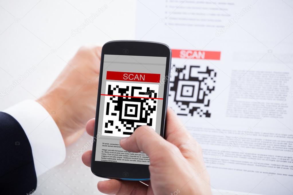 Close-up Of Businessman Scanning A Barcode