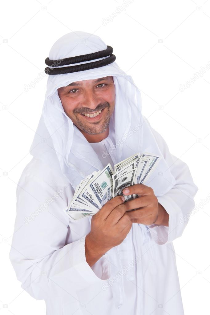 Portrait Of Mature Arab Man Holding Dollars