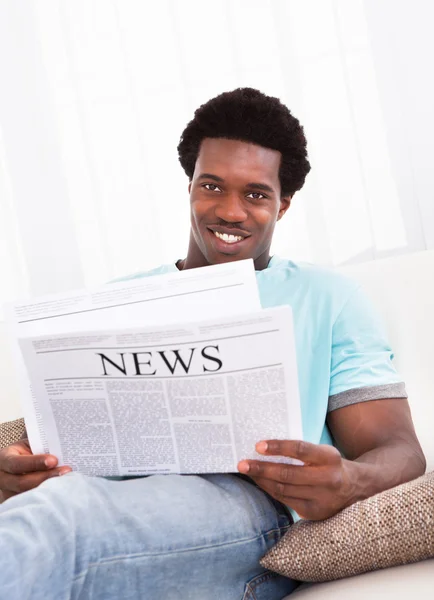 Young African Man Reading Newspaper — Stock Photo, Image