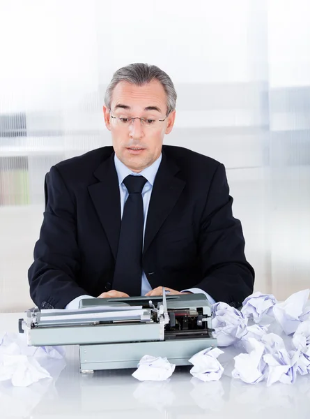 Reifer Geschäftsmann tippt auf Schreibmaschine — Stockfoto