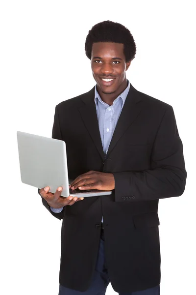 Feliz hombre de negocios sosteniendo portátil —  Fotos de Stock